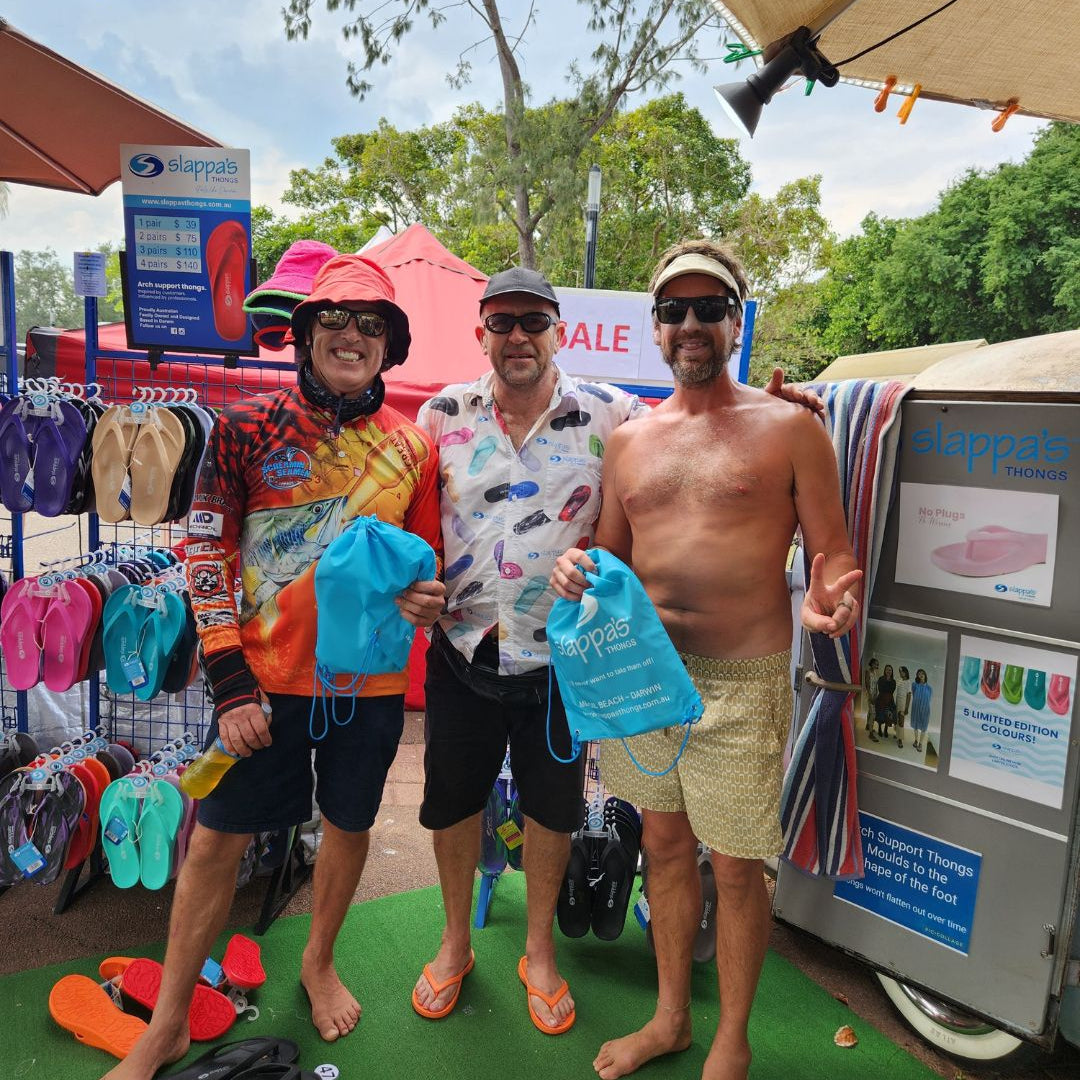 Roger from Slappa's Thongs presenting the winners of the Darwin Lions Beer Can Regatta Slappa's Thongs throwing competition