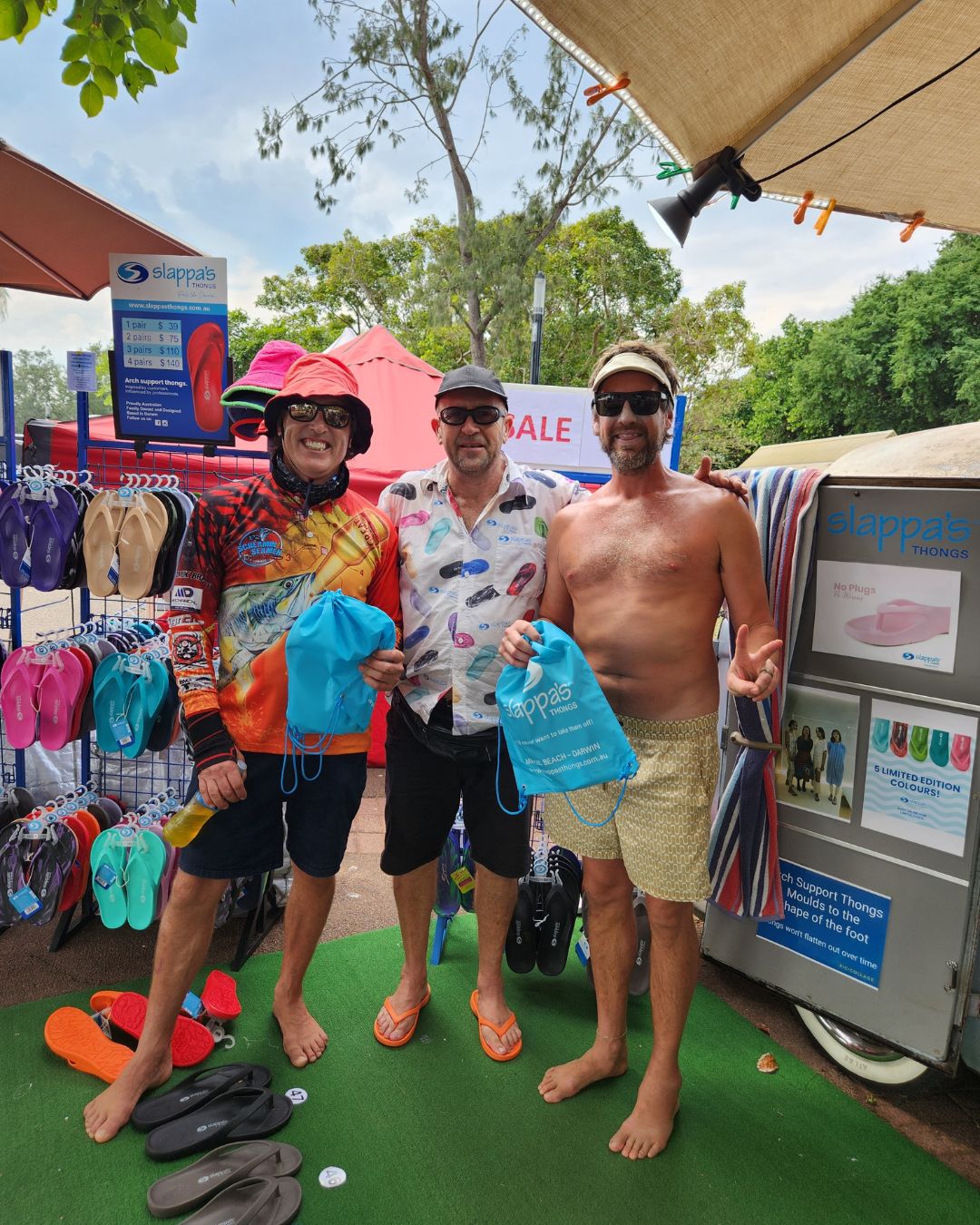 Roger from Slappa's Thongs presenting the winners of the Darwin Lions Beer Can Regatta Slappa's Thongs throwing competition