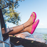Pink Slappas durable arch support thongs with legs and feet out the Kombi
