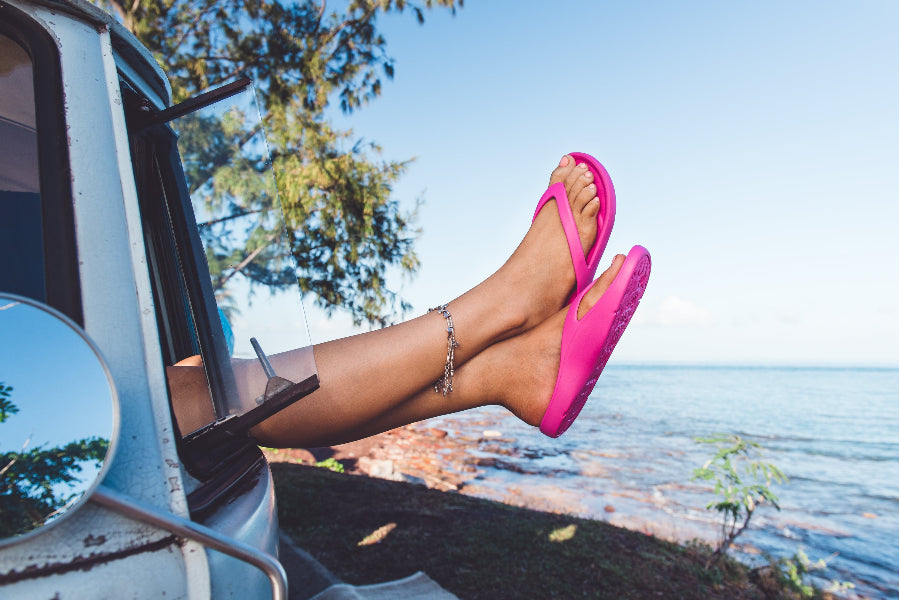 Pink Slappas durable arch support thongs with legs and feet out the Kombi