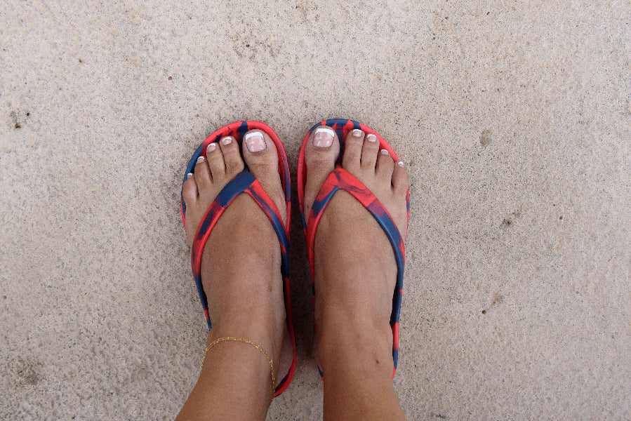 Red and Blue Slappas durable arch support thongs worn as casual footwear