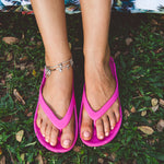 Pink Slappas durable arch support thongs worn at a picnic